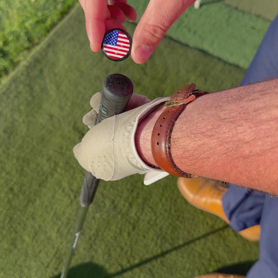 Person installing a Grip Topper onto a golf club at a golf course