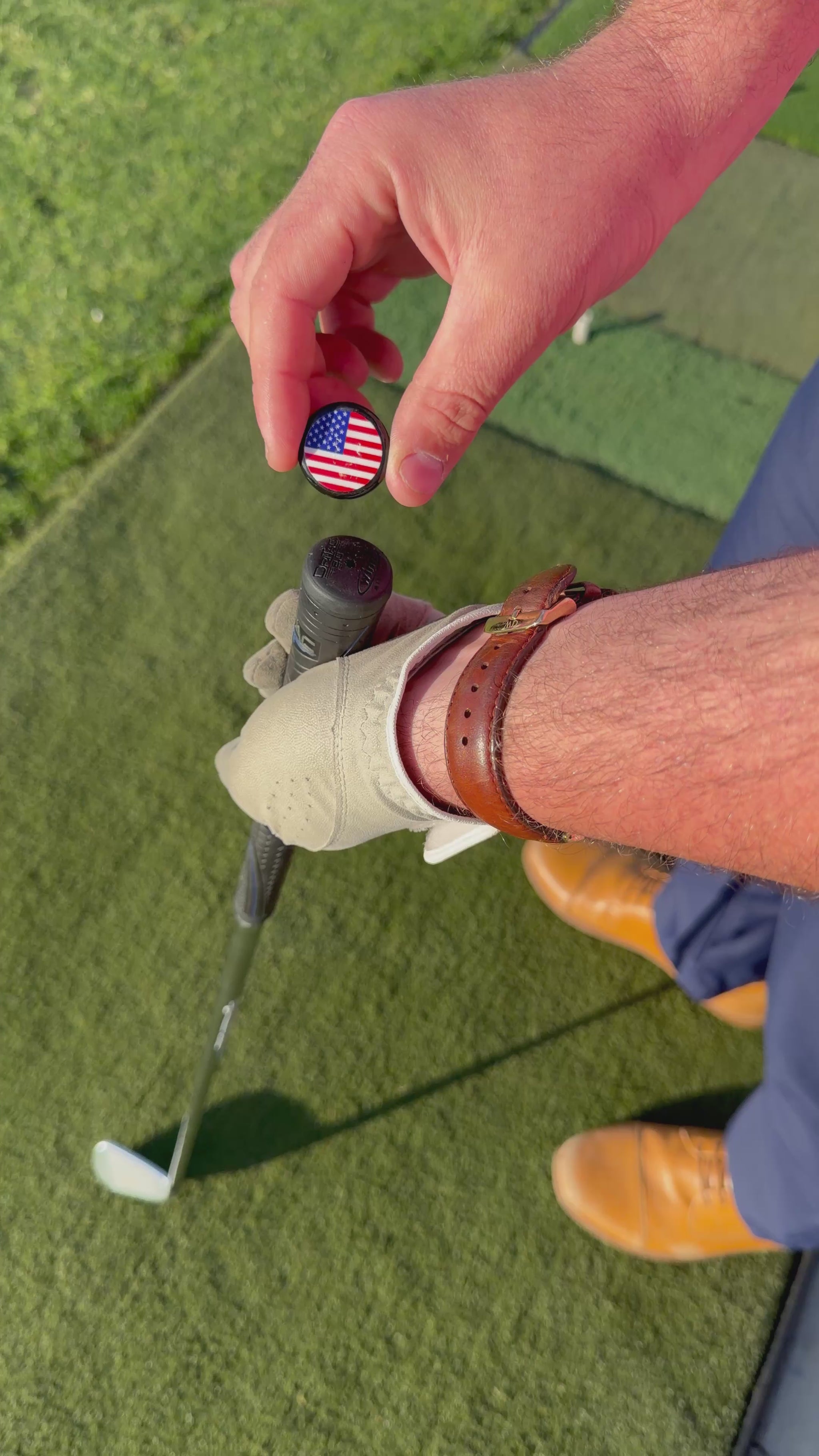 Person installing a Grip Topper onto a golf club at a golf course